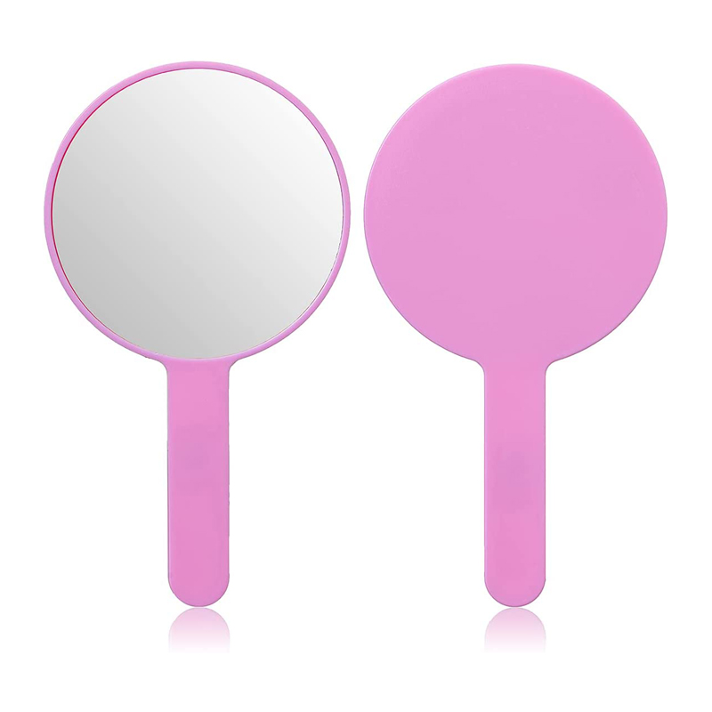 Rundt dekorativt lyserødt håndholdt spejl